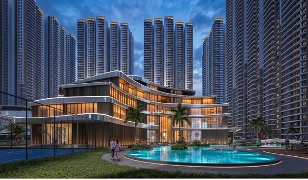 A large outdoor luxury swimming pool with a wooden sun deck and lounge chairs surrounded by manicured landscaping.