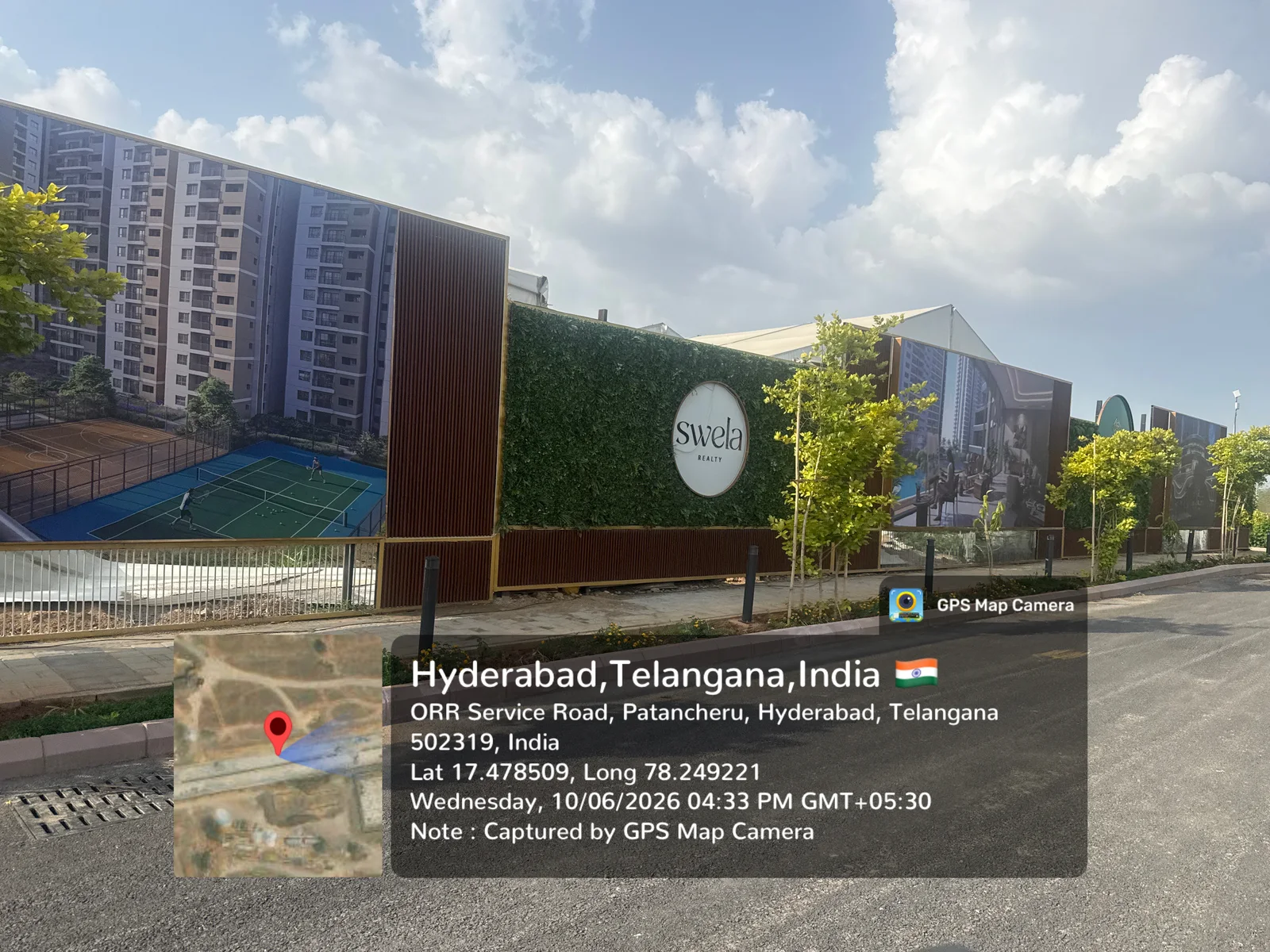 Swela-branded marketing pavilion with a tennis / sports court at Prestige Golden Grove, Velimela, June 2026.