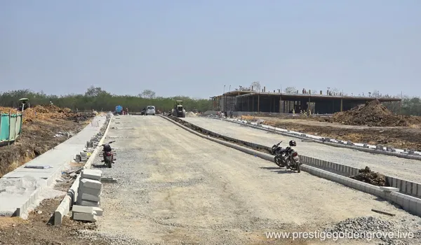 Newly laid internal road with kerb-stones leading to the early sales-gallery structure at Prestige Golden Grove, Velimela.