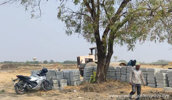 Stacked kerb-stones and construction materials with a roller/compactor during ground work at Prestige Golden Grove, Velimela.